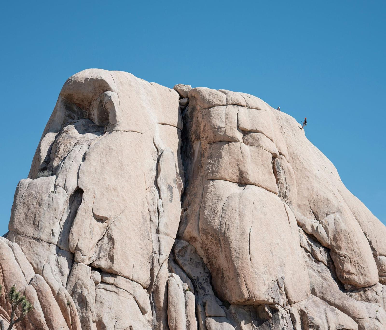 Climbers high on a desert granite dome